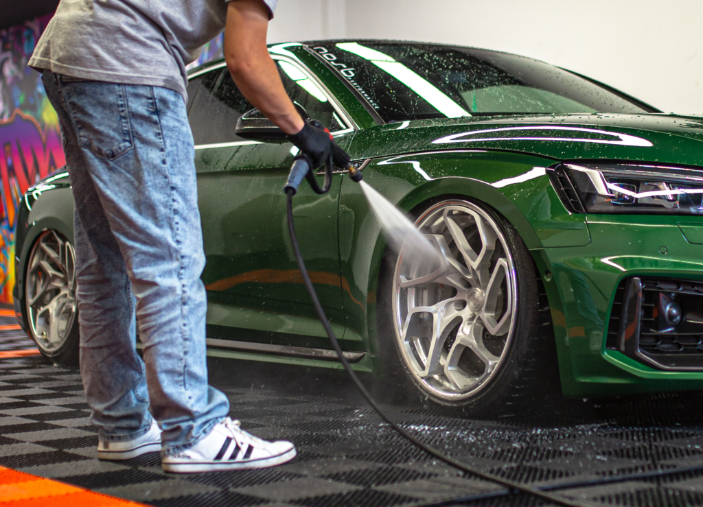 cleaning car wheels with pressure washer